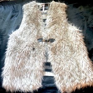 A small used faux fur vest ,with a crochet back.